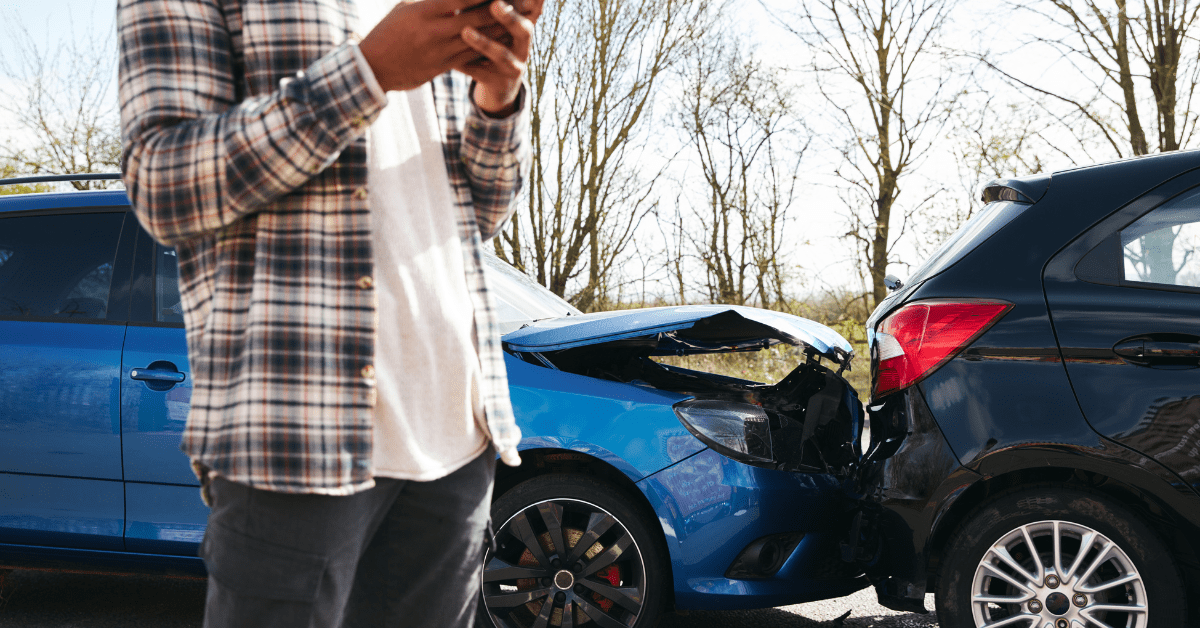 Driver inspecting vehicle damage after collision, car accident guide