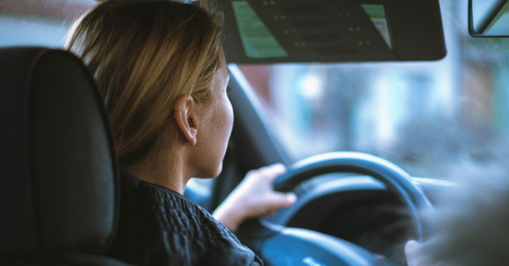 Woman focused on the road while driving, illustrating safe driving practices.