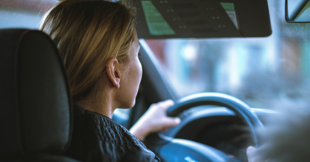 Woman focused on the road while driving, illustrating safe driving practices.